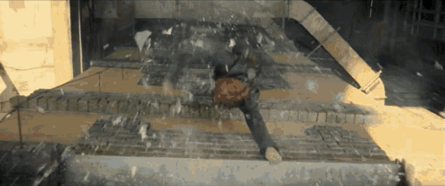 a person is laying on a brick floor with a basketball in their hand