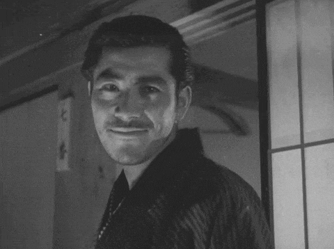 a man with a mustache and a striped shirt is smiling