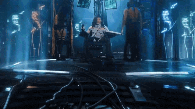 a man is sitting in a chair in front of a screen that says ' eee ' on it