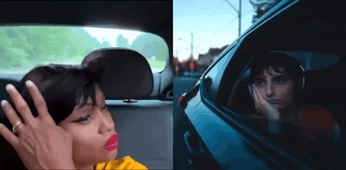 a woman sitting in a car with her hand on her head