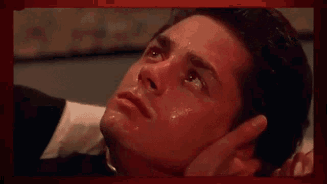 a man is laying on the floor with blood coming out of his nose .