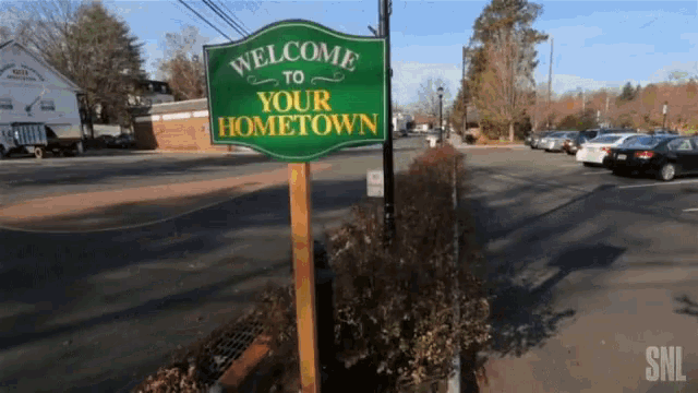 a green sign that says welcome to your hometown on it