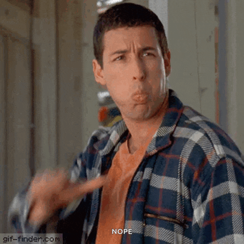a man in a plaid shirt is making a funny face and says nope