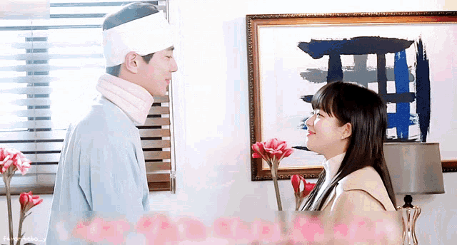 a man with a bandage on his head and a woman looking at each other