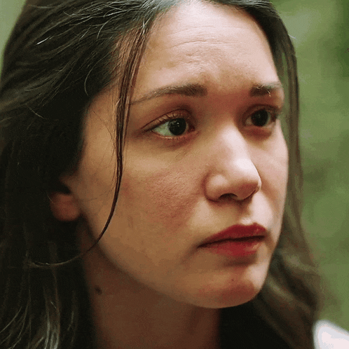 a close up of a woman 's face with her eyes closed