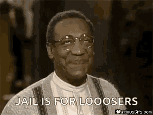 a man with glasses and a sweater is smiling and saying `` jail is for looosers '' .