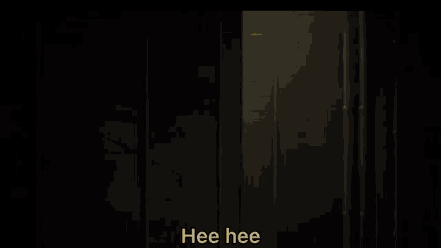a man in a hat is peeking out from behind a door .
