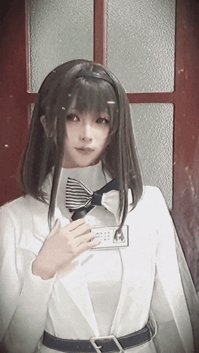 a woman wearing a white jacket and a bow tie has a name tag that says ' amanda ' on it