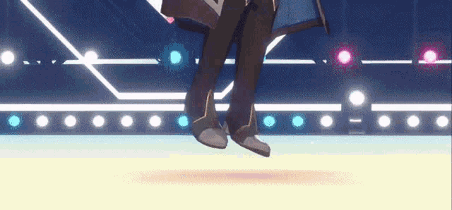 a person is flying through the air on a stage with lights behind them .