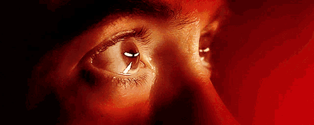 a close up of a person 's eye with a dark background