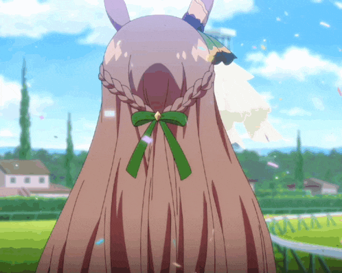 a horse with a braided mane and a green bow