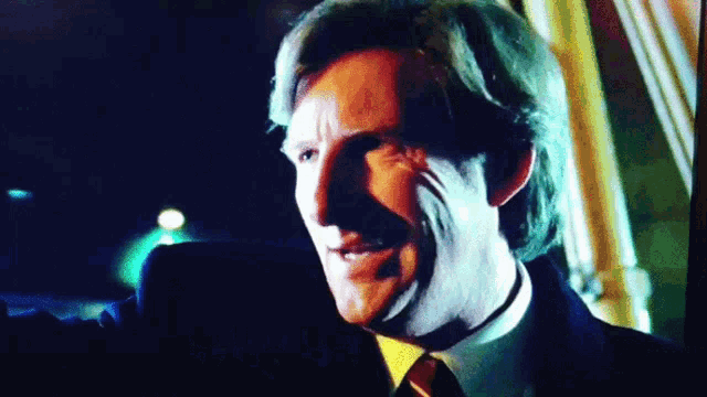a close up of a man 's face with a dark background