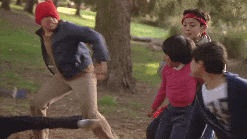 a group of young boys are playing a game in a park .