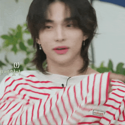 a close up of a person wearing a red and white striped shirt