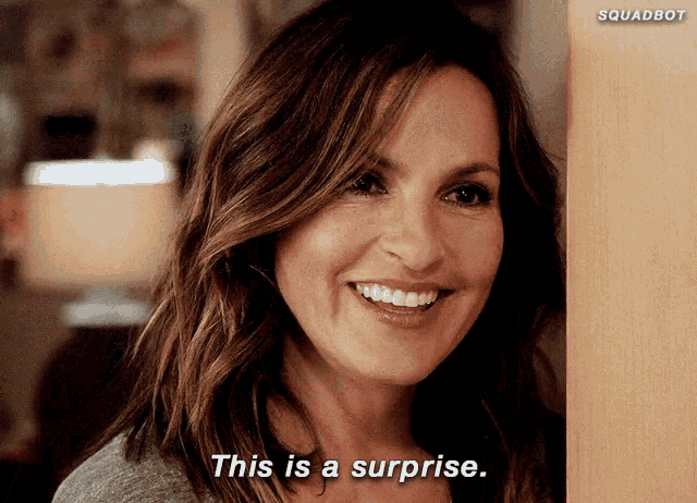 a woman smiles and says " this is a surprise " in front of a squadbot logo