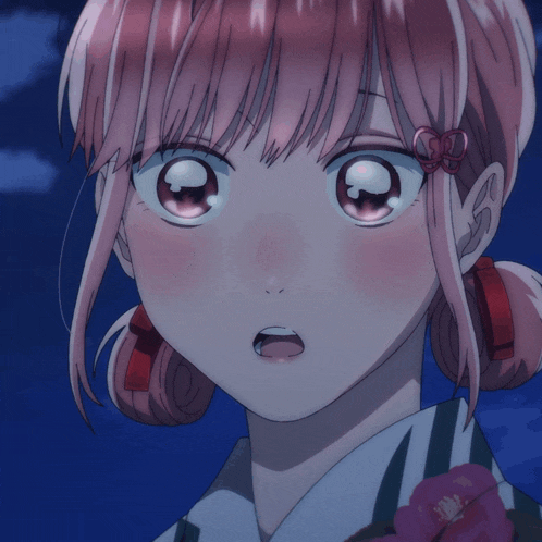 a close up of a girl 's face with a flower in her hair
