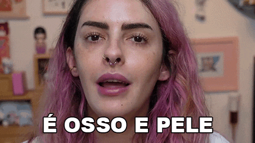 a woman with pink hair and a nose ring is making a funny face and saying e osso e pele .