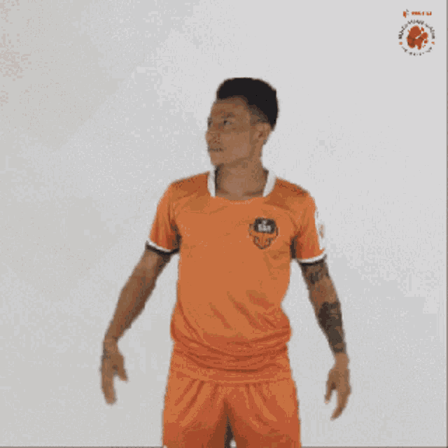 a man with a tattoo on his arm is waving