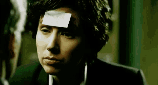 a woman has a piece of paper taped to her forehead that says ' i 'm sorry '
