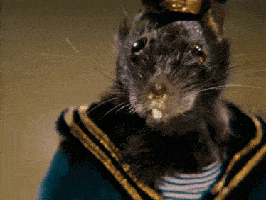a close up of a rat wearing a striped shirt and a sailor 's uniform