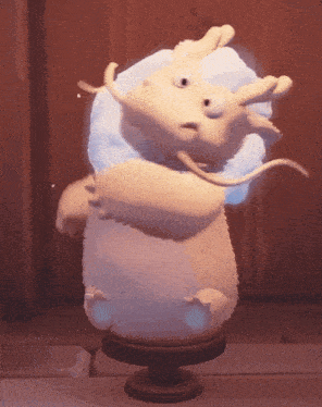 a statue of a white animal with horns and a blue glowing tail