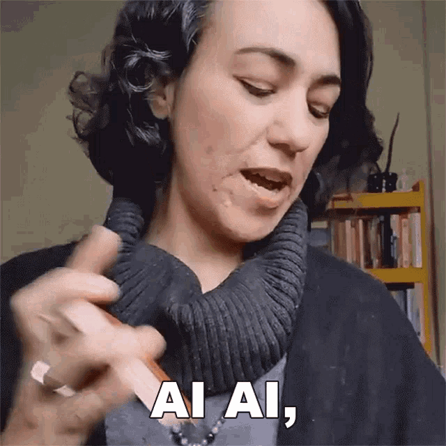a woman in a black sweater says ai ai in white letters