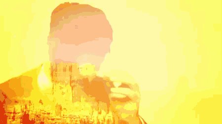 a double exposure of a man eating a sandwich with a mountain in the background