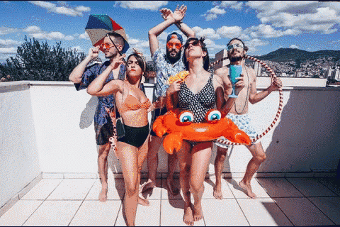 a group of people standing on a rooftop with a crab float