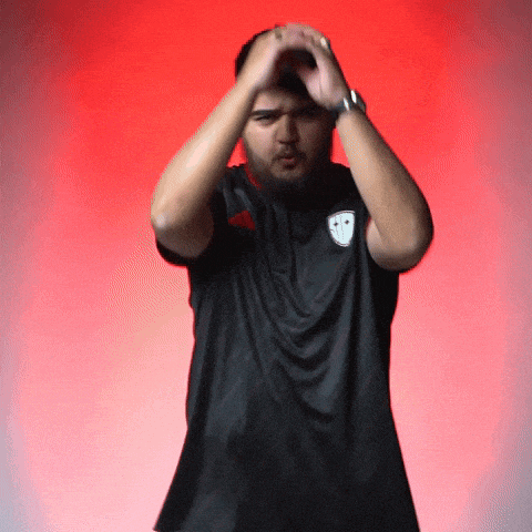 a man with a beard wearing a black shirt with a smiley face on it