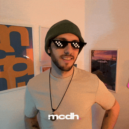 a man wearing a beanie and sunglasses with the word mcdh on the bottom right