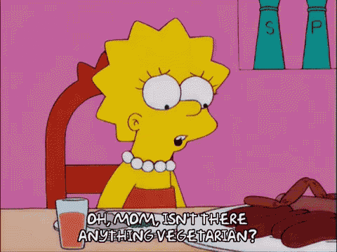 a cartoon of lisa simpson sitting at a table with a plate of food and a glass of orange juice ..