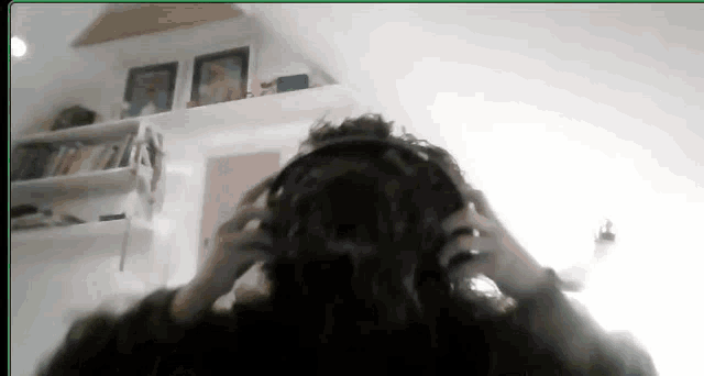 a person wearing headphones in a room with a green border