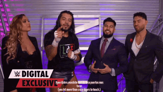 a group of wrestlers are standing in front of a sign that says ' digital exclusive '