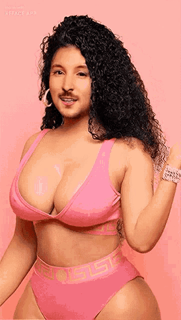 a woman in a pink bikini with the word versace on the bottom