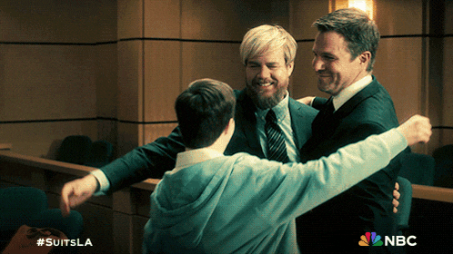 three men hugging each other in a courtroom with nbc written on the bottom