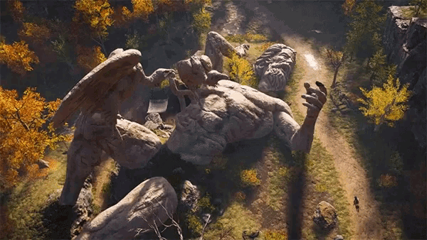 a statue of a man with wings is laying on top of a rock .