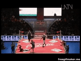 a boxing match is being shown on a television screen