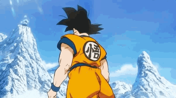 goku from dragon ball z is standing in front of a snow covered mountain .