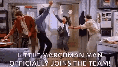 a group of people are dancing in a living room with the caption `` little marchman man officially joins the team ! ''