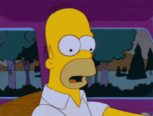homer simpson is driving a car with his mouth wide open