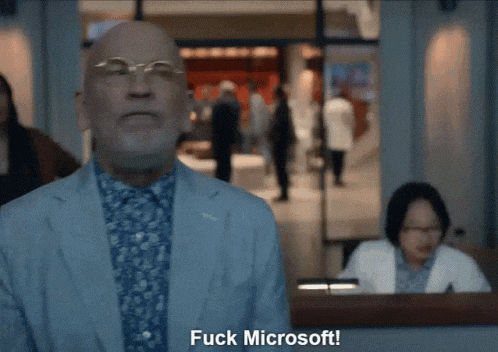 a man in a suit says " fuck microsoft "