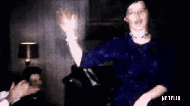 a woman in a blue dress is dancing in front of a man .