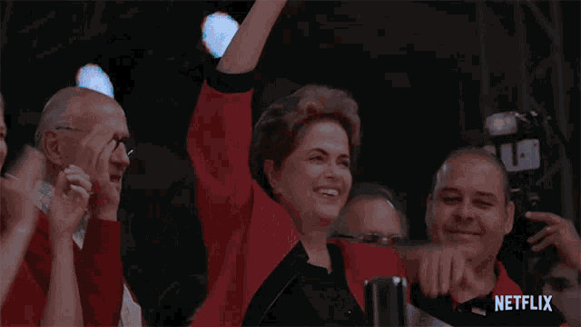 a netflix ad shows a woman in a red shirt raising her hand