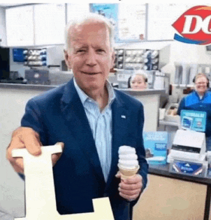 a man in a suit is holding an ice cream cone and a sign that says l.