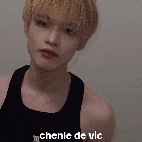 a young man wearing a black tank top with the word chenle de vic on the bottom