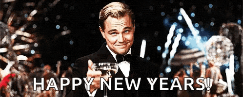 a man in a tuxedo is holding a glass of champagne with the words happy new years behind him