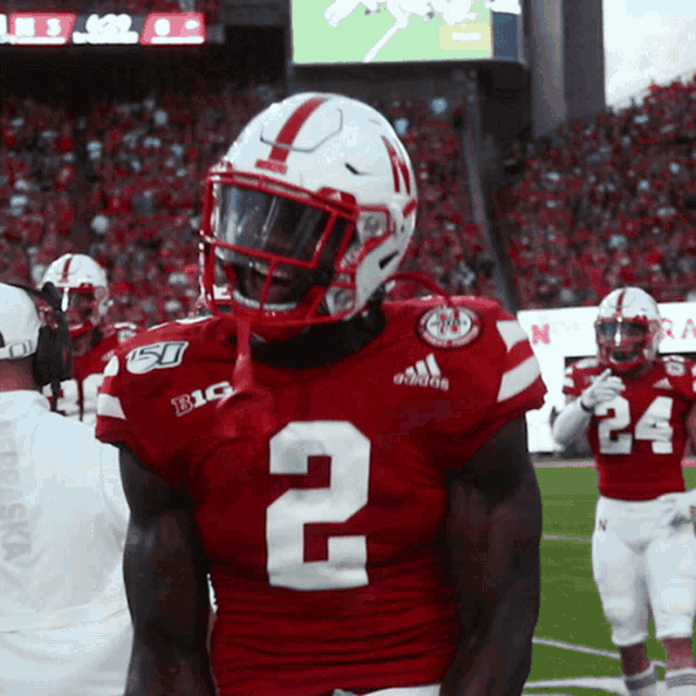 a football player wearing a red jersey with the number 2