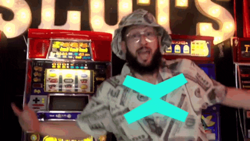 a man with a beard is standing in front of a slot machine with a blue cross on his chest