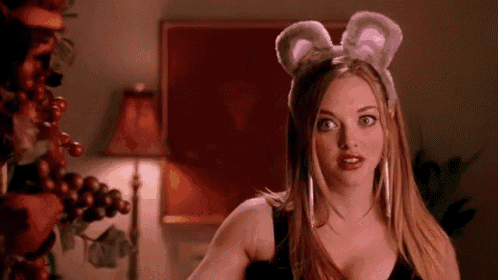 a woman wearing a headband with bunny ears is standing in a living room .