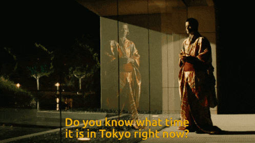 a man in a kimono stands in front of a glass wall with the words " do you know what time it is in tokyo right now "